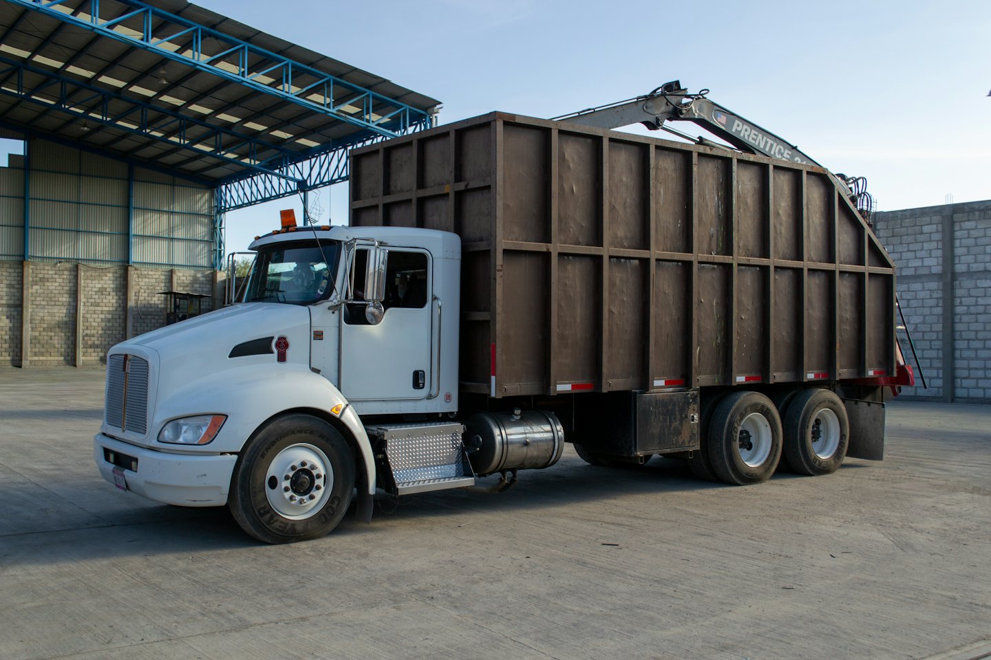 Heavy duty dump truck parked at an industrial site.